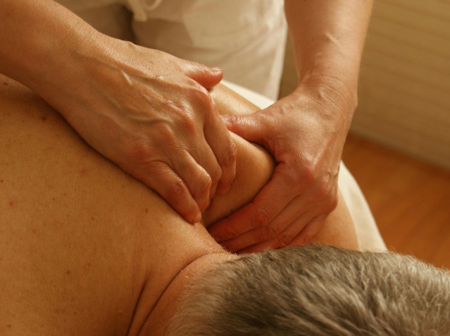 Client receiving a deep tissue massage to relieve muscle tension and chronic pain at our Pacific Beach wellness center in San Diego